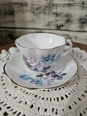 Elegant Blue Floral Porcelain Teacup and Saucer with Gold Trim